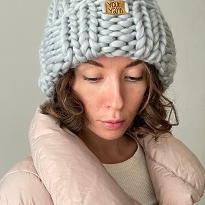 May include: A light grey knitted beanie with a "Your Yarn" label.