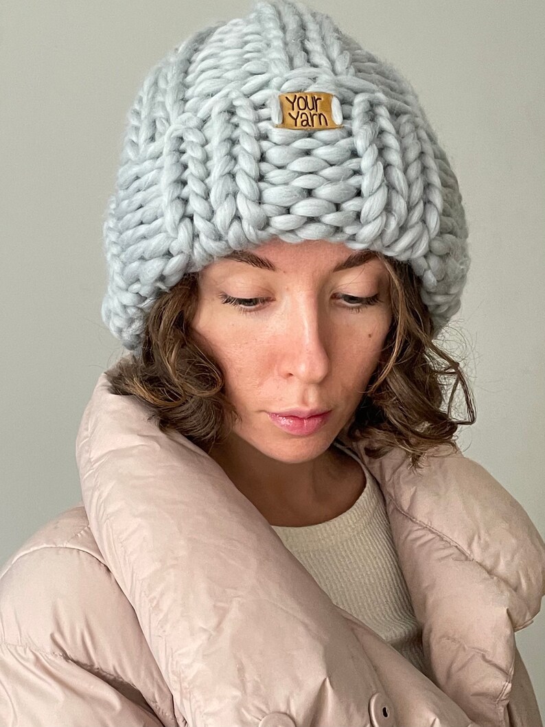 May include: A light grey knitted beanie with a "Your Yarn" label.