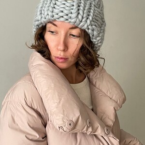 May include: A grey knitted beanie with a brown leather tag that says "Your Yarn".