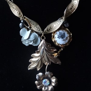 Vintage flowers and handpainted milk glass with gold tone chain necklace.