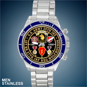 May include: A stainless steel watch with a blue and silver bezel. The watch face features the U.S. Army 25th Infantry Division emblem, the text "U.S. ARMY 25TH INF", and the text "MEN STAINLESS".