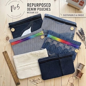 May include: Six rectangular pouches made from repurposed denim and fabric, featuring various textures, patterns, and zips. One pouch has a rainbow-coloured zip, while others have black zips. A wooden ruler is visible on the left side.