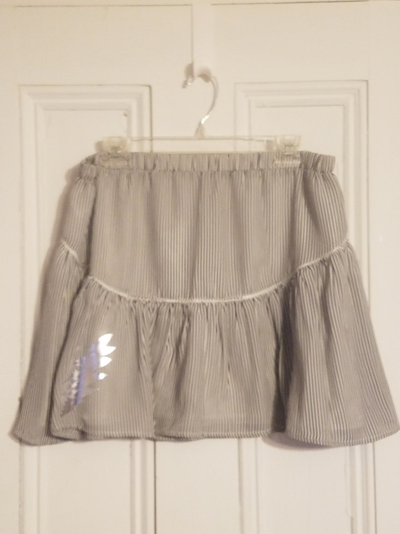 Upcycled Banana Republic short skirt size Medium with stripes and 13-point Bolt.
