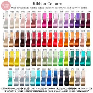 May include: A colour chart of satin ribbons in a wide range of shades, from white to black. The image shows over 60 ribbon colours, each with a name and number. Text at the bottom reads, "Ribbon photographed in studio light - please note colours may appear different."