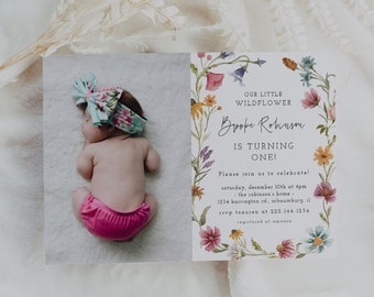 May include: A floral-themed baby shower invitation with a wreath of colorful flowers surrounding the text "Our Little Wildflower Brynn Robinson is turning one!"  Please join us to celebrate Saturday, December 10th at 4pm. The Robinson's Home 1014 Harrington Rd. Williamsburg, VA 23185 RSVP to 555-144-3234.