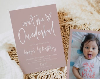 May include: A pink and white invitation card with the text "Isn't she Onederful" and "Brook's 1st Birthday". The invitation includes the date, time, and location of the party. A separate pink card features a photo of a baby girl wearing a white onesie with the text "One of a Kind" in pink. The text "Kennedy Thompson 10-20-22" is printed below the photo.