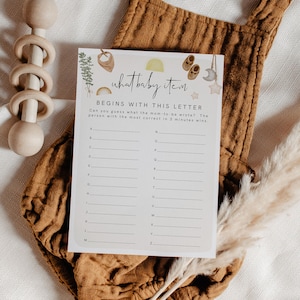 May include: A printable baby shower game card with the title "what baby item begins with this letter" and a list of letters A through Z with blank lines next to each letter.