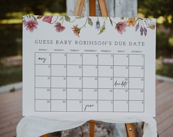 Op de afbeelding: Een witte kalender met een bloemige rand, met de titel "Raad de uitgerekende datum van Baby Robinson". De kalender toont mei en juni, waarbij 20 mei is omcirkeld en gelabeld als "uitgerekende datum".