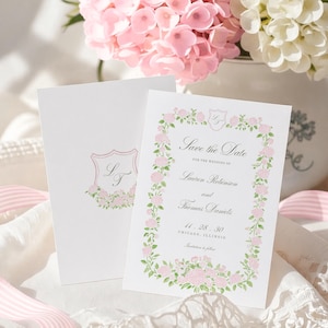 May include: Two white rectangular Save the Date cards featuring a pink and green floral border and a crest with the initials LT. The text reads: Save the Date for the wedding of Lauren Robinson and Thomas Daniels, 11.28.30, Chicago, Illinois.