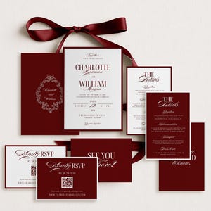 May include: A collection of burgundy wedding invitations and RSVP cards, tied with a matching ribbon. The main invitation features the names "Charlotte" and "William" in elegant typography. Additional cards include details and RSVP information.