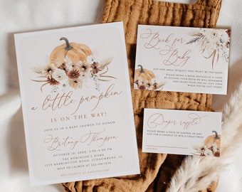 May include: A baby shower invitation with a watercolor illustration of a pumpkin, flowers, and pampas grass. The invitation reads "a little pumpkin is on the way!" and includes the date, time, and location of the event. There are also two smaller cards, one for a book request and one for a diaper raffle.