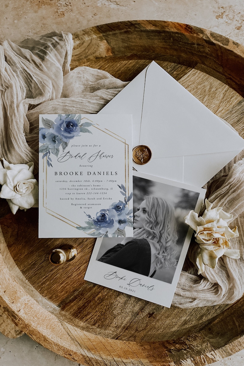 May include: A blue and gold bridal shower invitation with watercolor flowers and a photo of the bride-to-be. The invitation includes the date, time, location, and RSVP information. It also includes the text "Please join us for a Bridal Shower honoring Brooke Daniels".