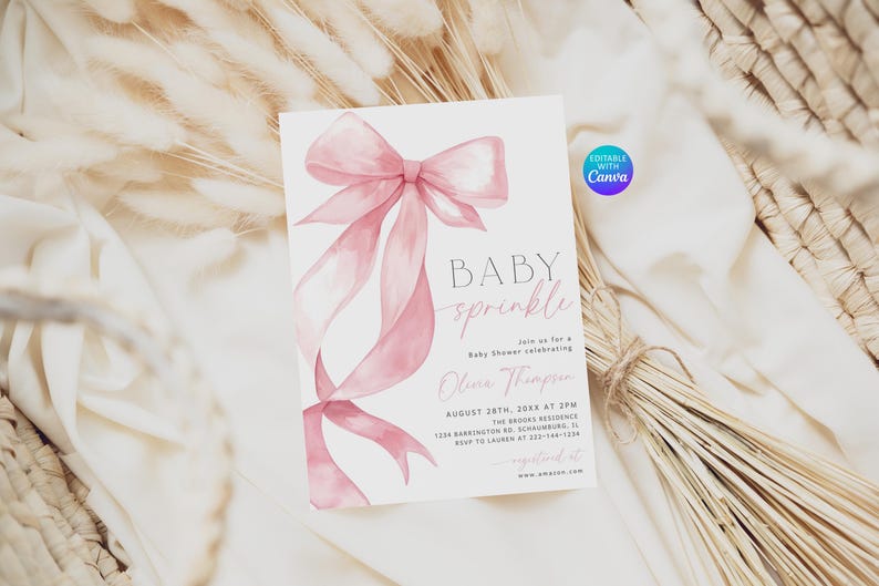 Pu&ograve; includere: Un biglietto d'invito per baby shower con un design ad acquerello di fiocco e nastro rosa. Il testo "BABY sprinkle" &egrave; visualizzato, insieme ai dettagli dell'evento. Il biglietto &egrave; ambientato su uno sfondo di fiori secchi e tessuto.