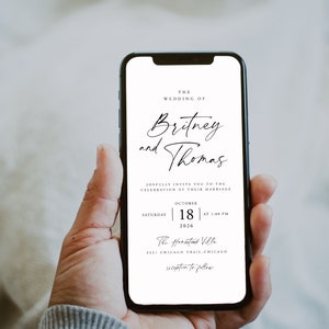 May include: A white wedding invitation on a smartphone screen. The invitation reads "The Wedding of Britney and Thomas" with the date and time of the wedding: "Saturday, October 18, 2026 at 1:00 PM". The location is "The Homestead Ville, 3331 Chicago Trail, Chicago" with the words "reception to follow" at the bottom.
