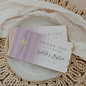 May include: White thank you card with gold trim and a purple watercolour background. The card says "Thank you for celebrating Isabella's Baptism, April 18th, 2021".