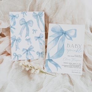 May include: Two baby shower invitations with a watercolor bow design. One card features multiple bows, while the other has a large bow with the text "BABY sprinkle" and event details. Soft blue and white color scheme.