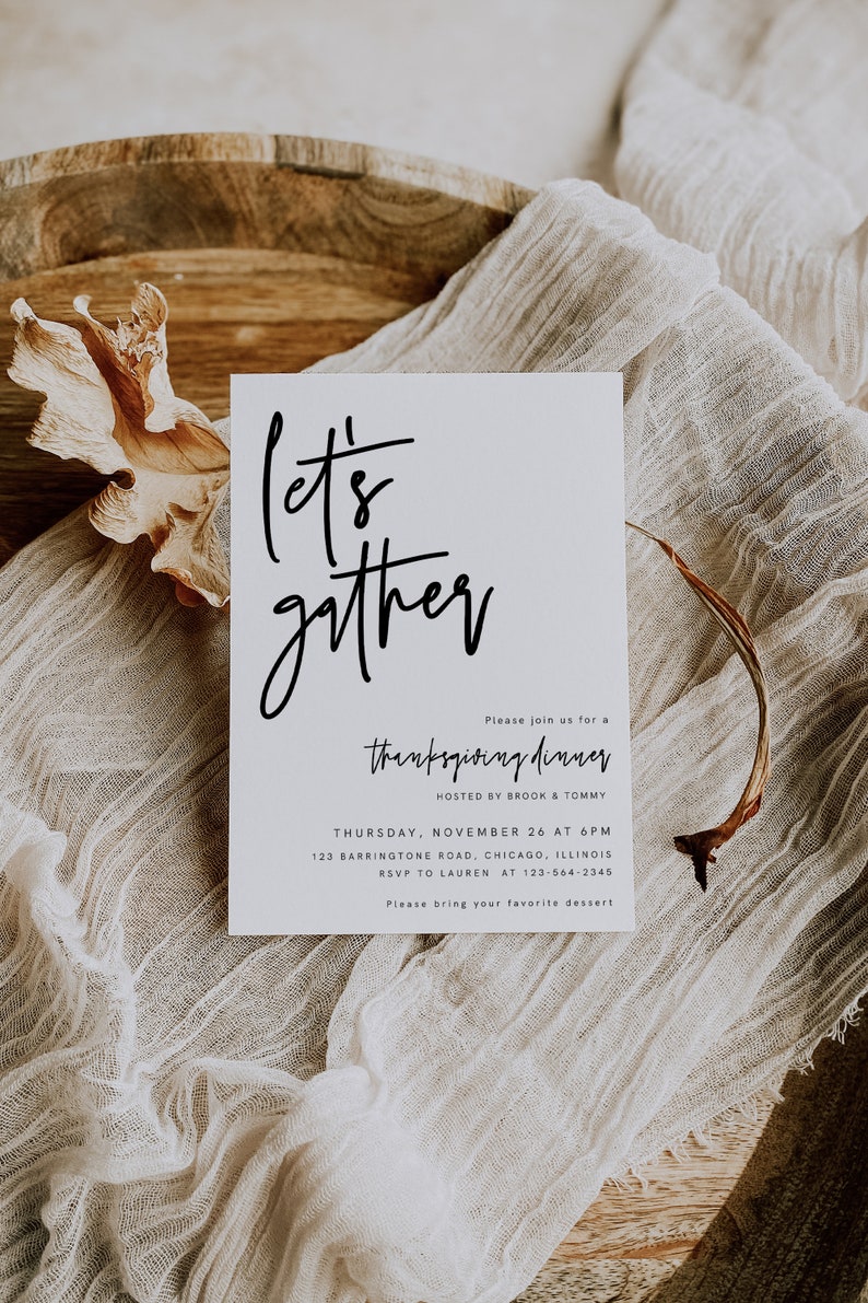 May include: A white card with black calligraphy that reads "Let's gather" and an invitation to a Thanksgiving dinner hosted by Brook and Tommy. The invitation includes the date, time, address, and RSVP information.