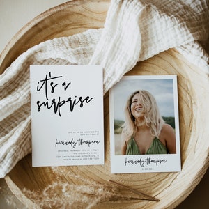 May include: A white card with black calligraphy that reads "it's a surprise" and details for a birthday party. The card is next to a photo of a woman smiling with her hair covering her face. The text on the photo reads "kennedy thompson 10-08-22".