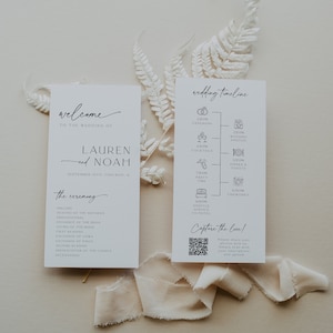 May include: Two white cards with black text. The left card says "Welcome to the wedding of Lauren and Noah, September 10th, Chicago, IL." The right card says "Wedding Timeline" and lists the times for the ceremony, wedding photos, cocktails, dinner and toasts, party time, shuttle service to hotel, and fireworks. The cards are on a light brown background with a white fern.