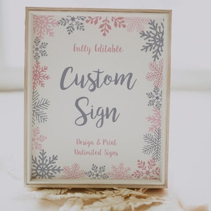May include: A white sign with a wooden frame and a pink and gray snowflake border. The sign says "Fully Editable Custom Sign Design & Print Unlimited Signs".