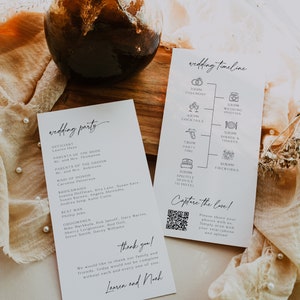 May include: A wedding timeline and wedding party list printed on white cards. The timeline includes icons for the ceremony, wedding photos, cocktails, party time, shuttle service to the hotel, dinner and toasts, and fireworks. The wedding party list includes the officiant, maid of honor, bridesmaids, best man, and groomsmen. The cards are on a wooden table with a brown glass vase and dried flowers.