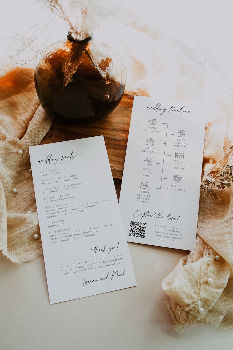 May include: A wedding timeline and wedding party list printed on white cards. The timeline includes icons for the ceremony, wedding photos, cocktails, party time, shuttle service to the hotel, dinner and toasts, and fireworks. The wedding party list includes the officiant, maid of honor, bridesmaids, best man, and groomsmen. The cards are on a wooden table with a brown glass vase and dried flowers.
