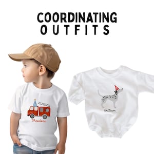 May include: Two white t-shirts with birthday themed designs. One shirt features a red fire truck with the name "Theodore" and the other shirt features a black and white dog wearing a party hat with the name "William".