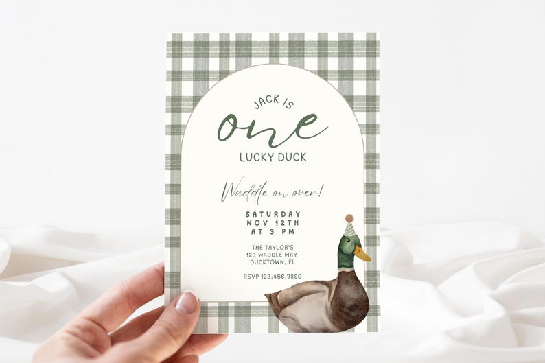 May include: A green and white checkered invitation card with a duck wearing a party hat. The text on the card reads "Jack is one Lucky Duck Waddle on over! Saturday Nov 12th at 3 PM The Taylor's 123 Waddle Way Ducktown, FL RSVP 123.456.7880"