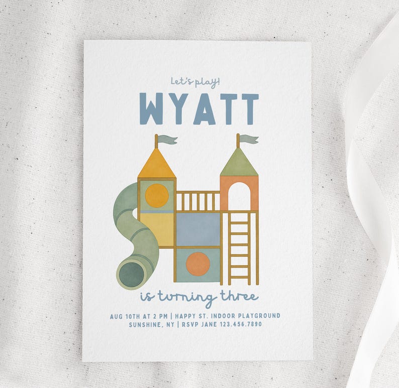 May include: A white invitation card featuring a playground illustration. The text "Let's play!" and "WYATT" are at the top. The text "is turning three" is in the middle, with event details at the bottom.
