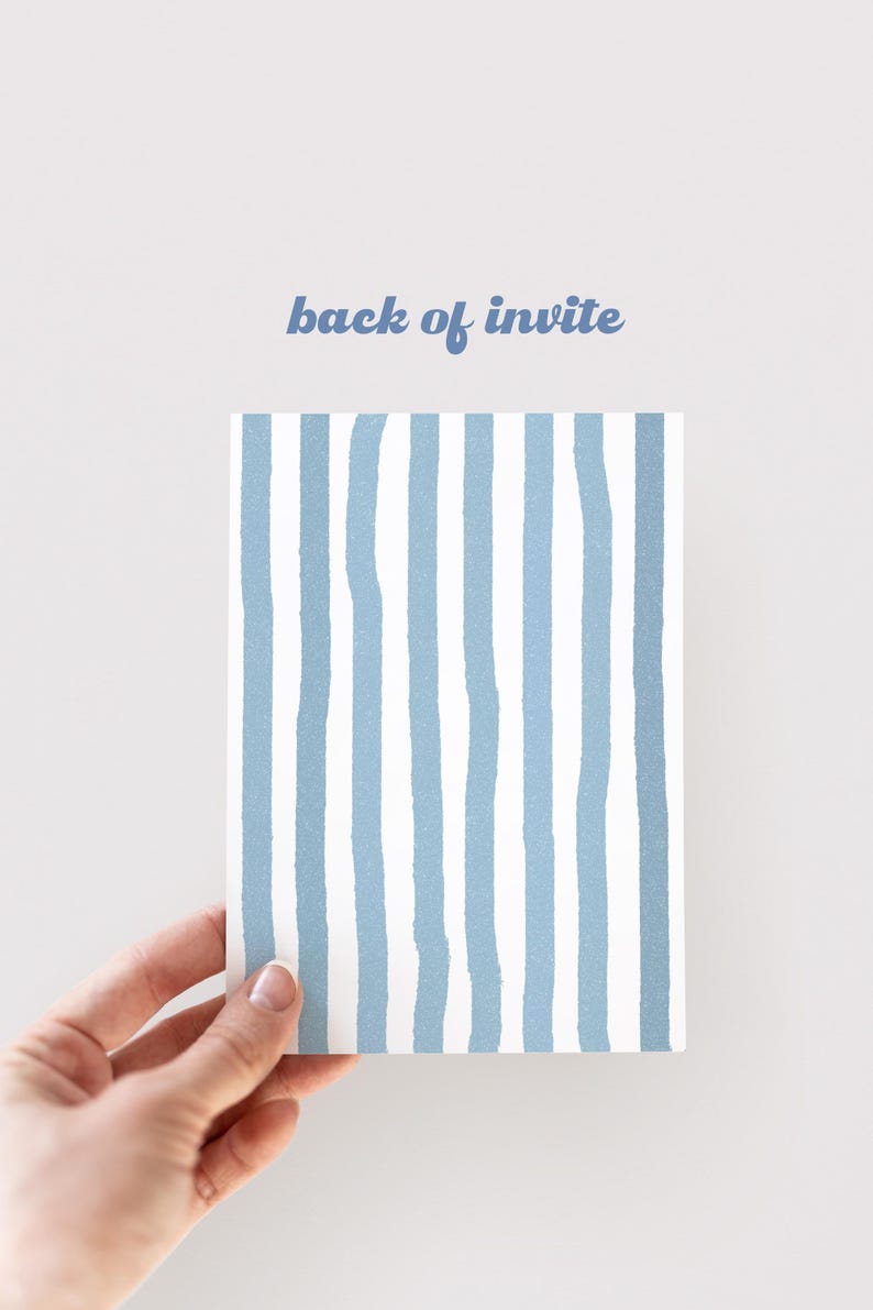 May include: A rectangular invitation card with a blue and white striped design. The text "back of invite" is written in blue script at the top. The card is held by a hand against a white background.