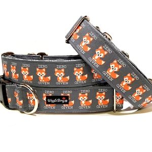 May include: Two grey dog collars with a repeating pattern of orange foxes and the text "Zero Given". The collars are made by "Wiggle Bums".
