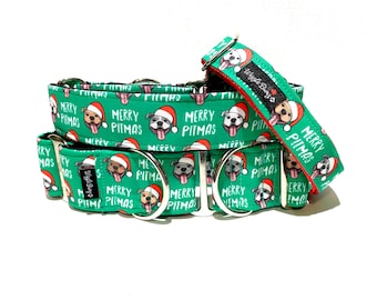May include: Green and red dog collar with a Christmas theme. The collar has a repeating pattern of a dog wearing a Santa hat and the text "Merry Pitmas".
