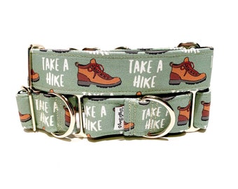 May include: A green dog collar with silver hardware features a repeating pattern of hiking boots and the text "Take a Hike". The collar is made by "Wuggle Bugs".