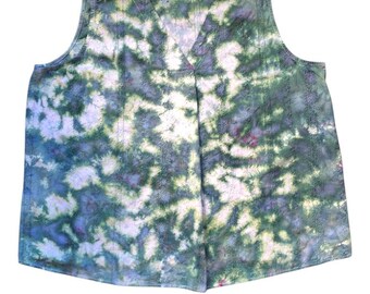 May include: A sleeveless, V-neck top with a tie-dye pattern in shades of green, blue, and white. The fabric appears to be hand-dyed, with a subtle texture and a small tag that reads "hand dyed". The top has a relaxed fit.