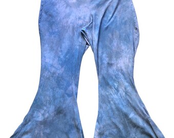 May include: Blue tie-dye bell bottom pants with a wide waistband. The pants have a flared leg design and a soft, textured appearance. The color palette includes shades of blue and gray.