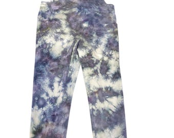 May include: Overalls with a tie-dye pattern in shades of blue, purple, and white. The overalls have adjustable straps, a bib front, and elastic cuffs at the ankles. The fabric appears to be soft and comfortable.