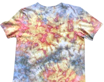 May include: A tie-dye V-neck t-shirt in a blend of colors including yellow, pink, blue, and gray. The short-sleeved shirt has a classic fit and a V-neck collar. The tie-dye pattern creates a unique, artistic look.