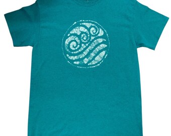 May include: Teal-colored t-shirt featuring a white circular design with swirling patterns. The graphic tee has short sleeves and a crew neck. The shirt is made of a soft material.