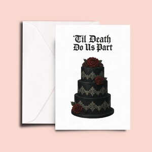 May include: A black wedding cake with white lace detailing and red roses. The cake is decorated with a gothic font that reads "'Til Death Do Us Part".