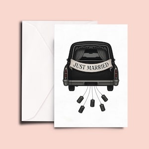May include: A black hearse with a "Just Married" banner and five empty cans tied to the back bumper.