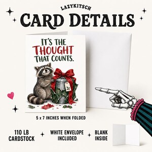 May include: A 5 x 7 inch folded greeting card made of 110 lb cardstock with a white envelope. The front features a raccoon next to a trash can wrapped as a gift with a red bow and the text IT'S THE THOUGHT THAT COUNTS. The inside is blank.