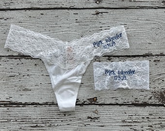 May include: White lace lingerie with a blue embroidered inscription that reads "Mrs. Wheeler 12.31.23".