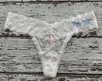 May include: White lace thong with the text "Mrs. Horton 4-14-2023" embroidered on the waistband.