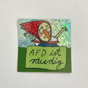 Könnte beinhalten: Quadratischer Aufkleber mit einer Comicfigur mit rotem Polka-Dot-Kopftuch, Brille und langer oranger Nase. Die Figur steht hinter einem grünen Schild mit dem Text "AFD ist räudig". Der Hintergrund hat einen Glitzereffekt.
