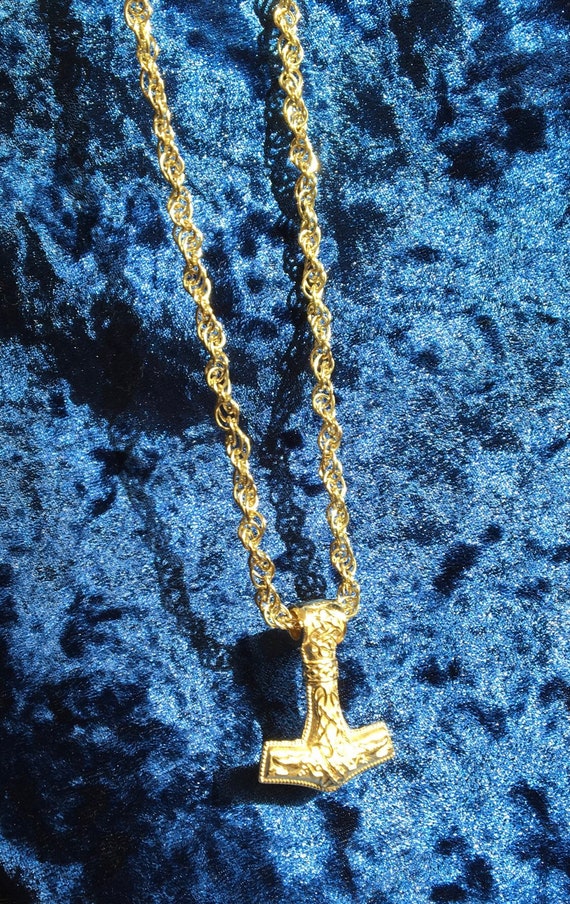 26 grams Rope chain yellow gold 14k, 28 grams Mjolnir 14k yellow gold.