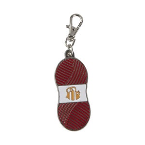 May include: A red and white metal keychain shaped like a ball of yarn with a bee logo. The keychain has a silver metal loop.