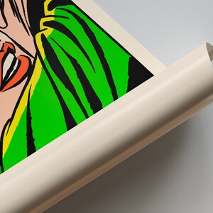May include: Close-up of a colorful comic book style illustration of a woman's face. The woman is wearing a green and yellow scarf. The image is printed on a white canvas.