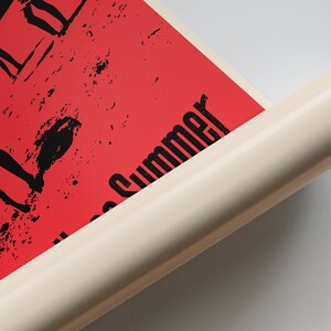 May include: A red poster with black silhouettes of people on a beach with the text "All Summer" in black.