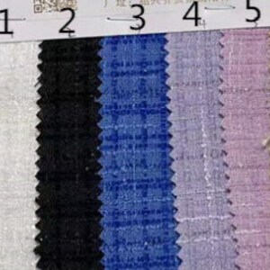 May include: Fabric swatch with five vertical stripes of different colors. From left to right, the colors are white, black, blue, lavender, and yellow. The fabric has a textured appearance.