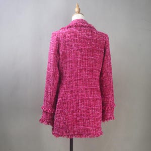 Back view of the handmade hot pink tweed blazer highlighting its structured fit, clean seam lines, and raw-edge fringe hem.